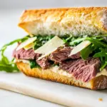 Homemade Roast Beef Sandwich with Arugula and Shaved Parmesan photo